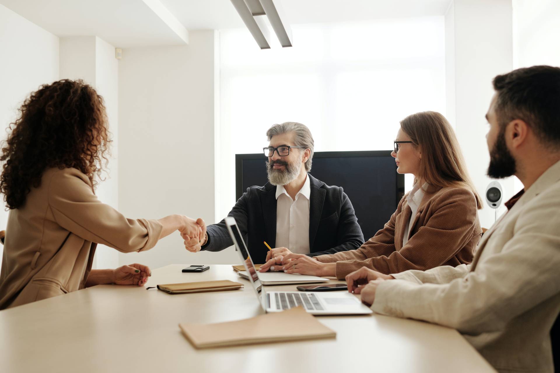 hiring woman shaking hands with team