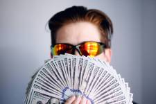 a man holding cash; https://www.legalzoom.com/articles/7-tips-for-choosing-a-business-name